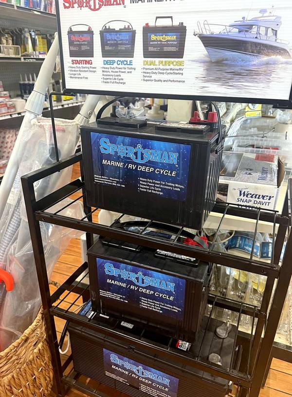 Sportsman marine deep-cycle batteries on a display rack