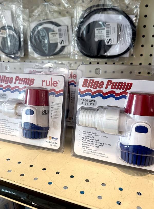 Rule bilge pumps and hoses on the store wall